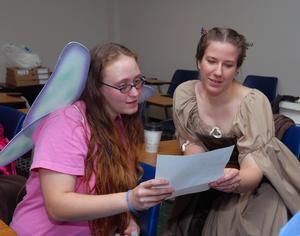 Winged fairy Sarah Dowda, left, and Tishia Tedder, right, as Hermia brush up on <em>A Midsummer Night's Dream</em>.