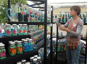 Artist Jo Stephens looks over one of her creations Saturday afternoon during opening day of the 2008 Virginia Highlands Festival in downtown Abingdon. (Photo by David Crigger, Bristol Herald Courier)