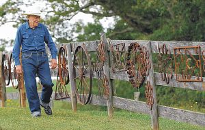 Lassiter Hoyle takes a stroll aruond his Damascus, Va. home, which includes a fence that features his metal pieces made out of horseshoes. (Photo by Earl Neikirk|Bristol Herald Courier).