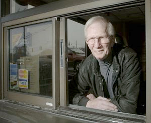 Charlie Green takes a last look out the drive-up window of his One Hour Photo business after 26 years serving the community. (Photo by Andre Teague, Bristol Herald Courier)