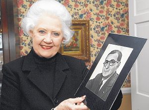 Peggy Rogers holds a photo of her favorite songwriter Irving Berlin. Rogers, along with other members of the Blue Stocking Club, will present Berlin's "I Love A Piano" on March 8, 2009 at the Paramount Center for the Arts in Bristol. Tenn. (Photo by Earl Neikirk|Bristol Herald Courier)
