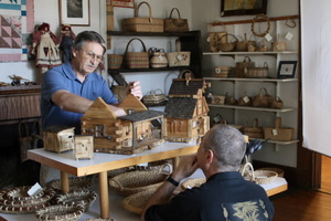 Bristol native Ray Hall is featured with his handcrafted miniature log cabins.