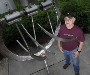 Virginia Intermont College 3-D arts professor and sculptor Marvin Tadlock looks over a recently completed kinetic sculpture that he made.
