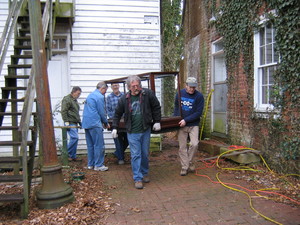 Moving a heavy six-foot display case, from left, are Ray Hall, Jeff Neil, John Dickens, Terry Clark, and Rees Shearer.
