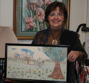 Penny Hite holds a landscape - crayon on canvas - that she created when she was about six years old. (Photo by Bob Cassell)