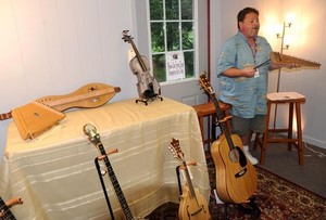 Gill Braswell holds a psaltry as he talks about instruments made in the Appalachian region. (Photo by David Crigger)