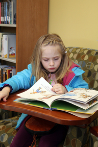 Ella Coburn enjoys reading at the public library in Glade Spring, Va.