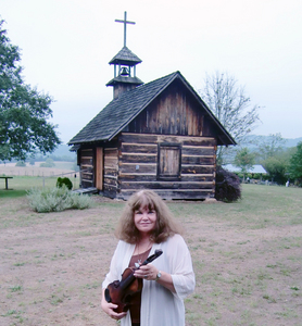 Sharyn McCrumb is holding Tom Dula's fiddle, which is on display at the Whippoorwill Museum in Wilkes County, N.C.