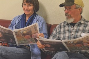 Two folks reading A! Magazine for the Arts while waiting for a show to open at the Mary B. Martin School of the Arts.
