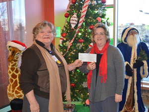 Proceeds from one of Milligan College's two Christmas concerts were presented to Niswonger Children's Hospital. Cookie McKinney (left) accepts the donation from Dr. Kellie Brown, chair of Milligan's music area. Additional proceeds will benefit Milligan's music area.
