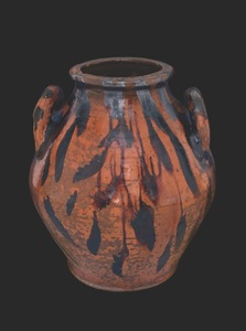 This earthenware, lead glaze and manganese decorated food jar is part of Mary Jo Case's collection. It is attributed to the Cain Pottery.