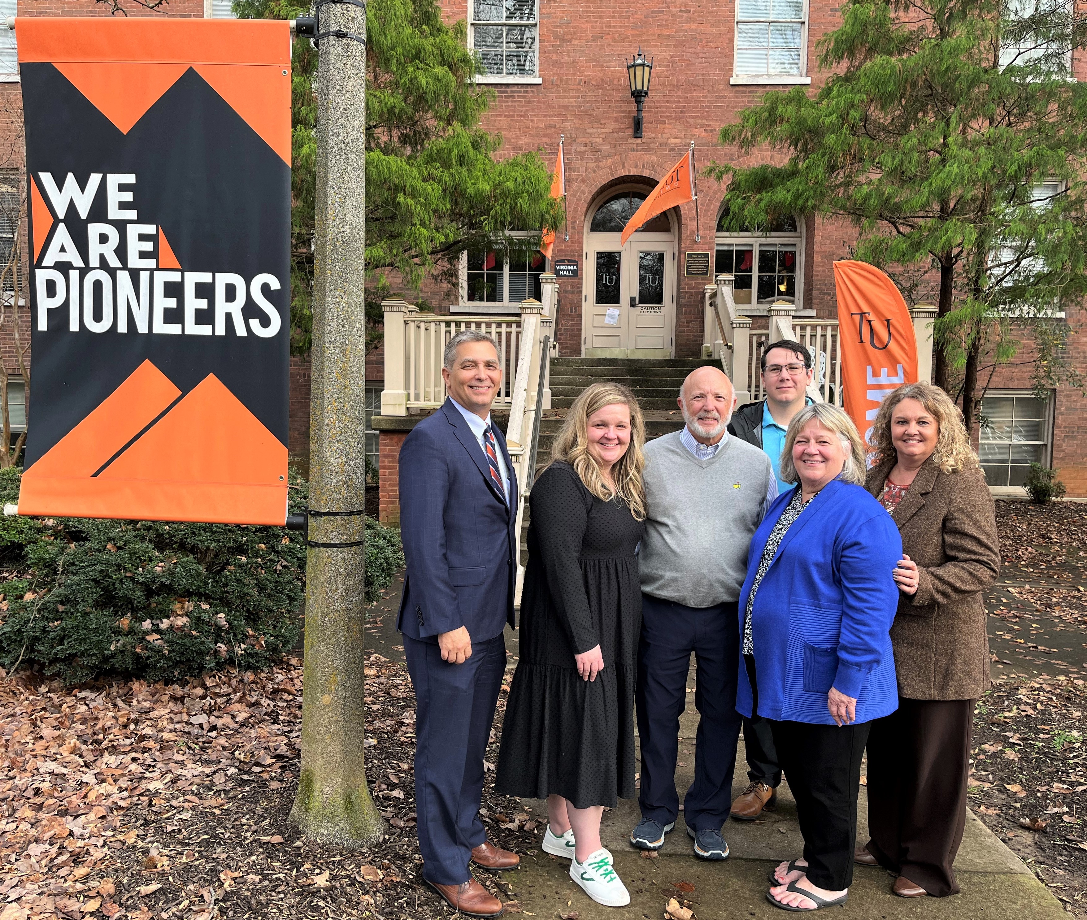 Left to right, Dr. Scott Hummel, Tusculum's president; Alison Sell, Harvey Sell, Dr. David Gonzalez, director of bands; Pam Sell, and Kim Kidwell, institutional advancement, gather on campus.