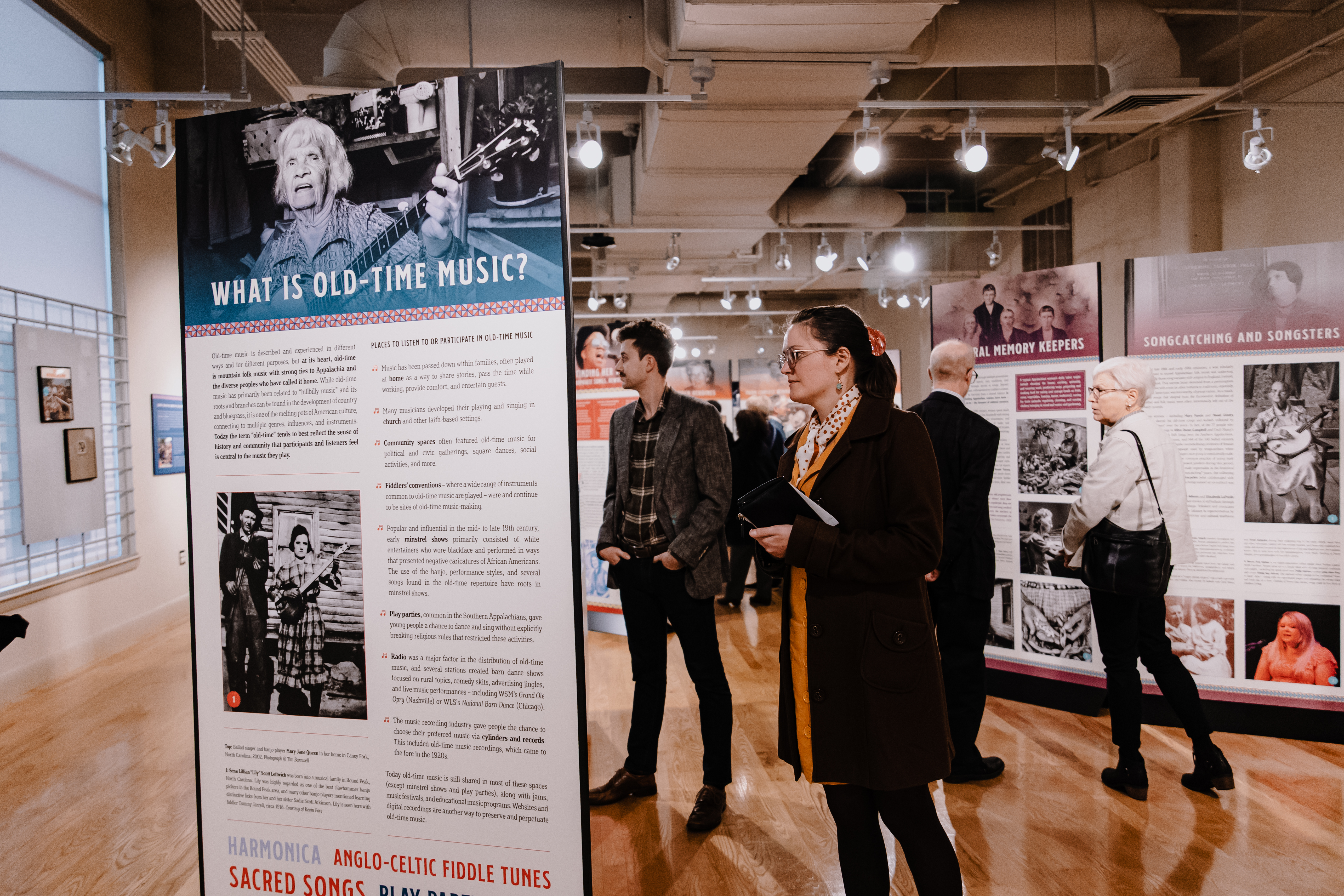 Museum goers visit the "I've Endured: Women in Old-Time Music" exhibit.