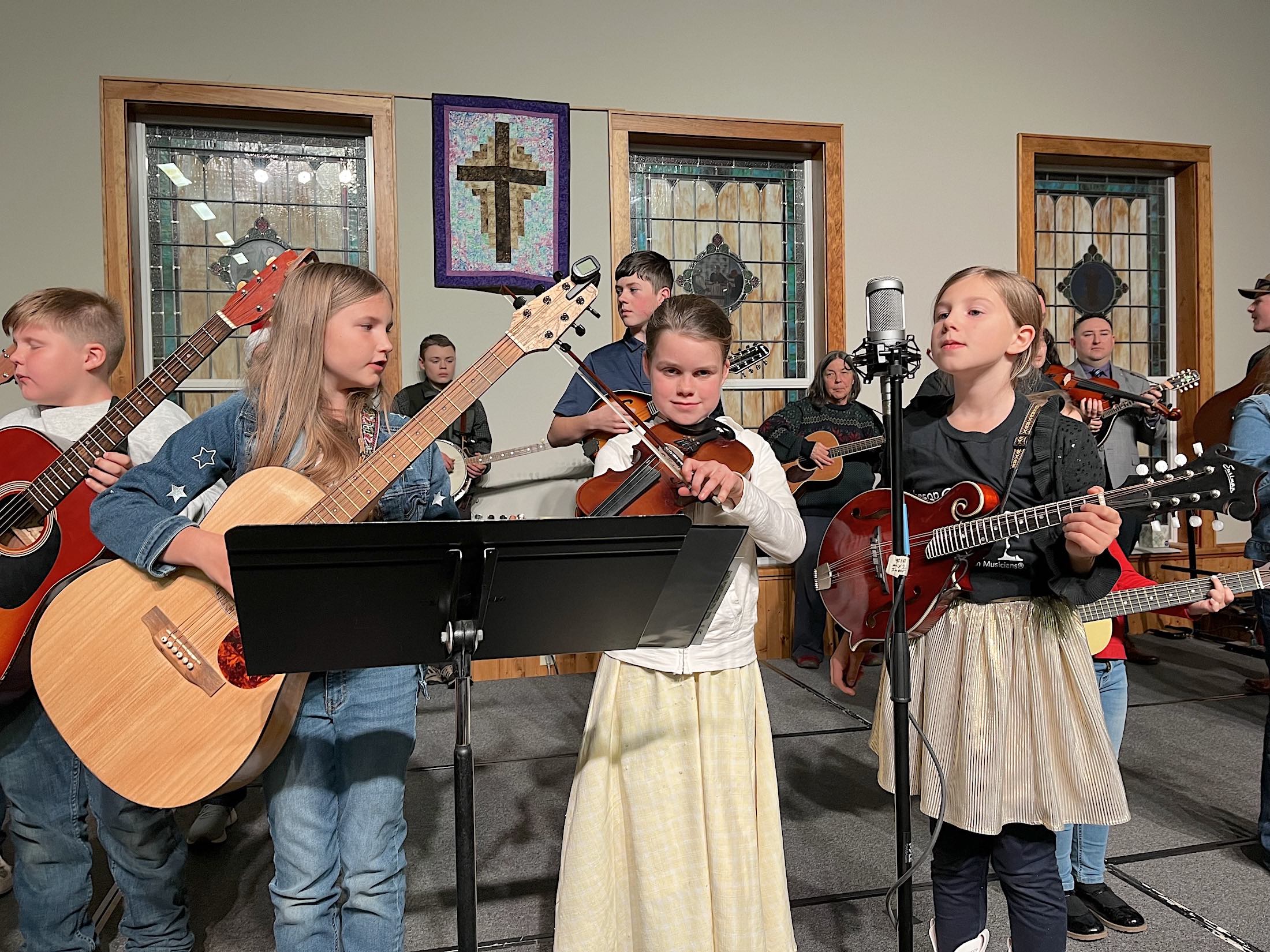 Junior Appalachian Musicians Julia Cornwell (guitar), Tabitha Ketola (fiddle), and Hazel Cornwell